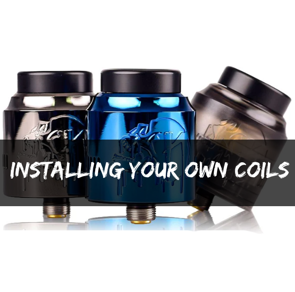 Three colourful RDA (Rebuildable Dripping Atomizer) vape tanks in black, blue, and gunmetal grey, with a dark central banner overlay featuring the white text "INSTALLING YOUR OWN COILS."